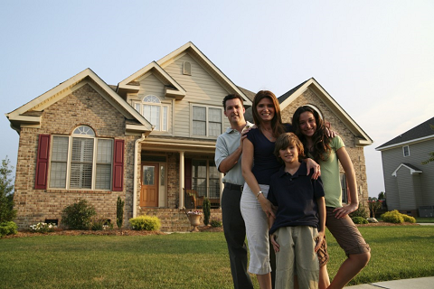 two-story-home-with-family-in-yard